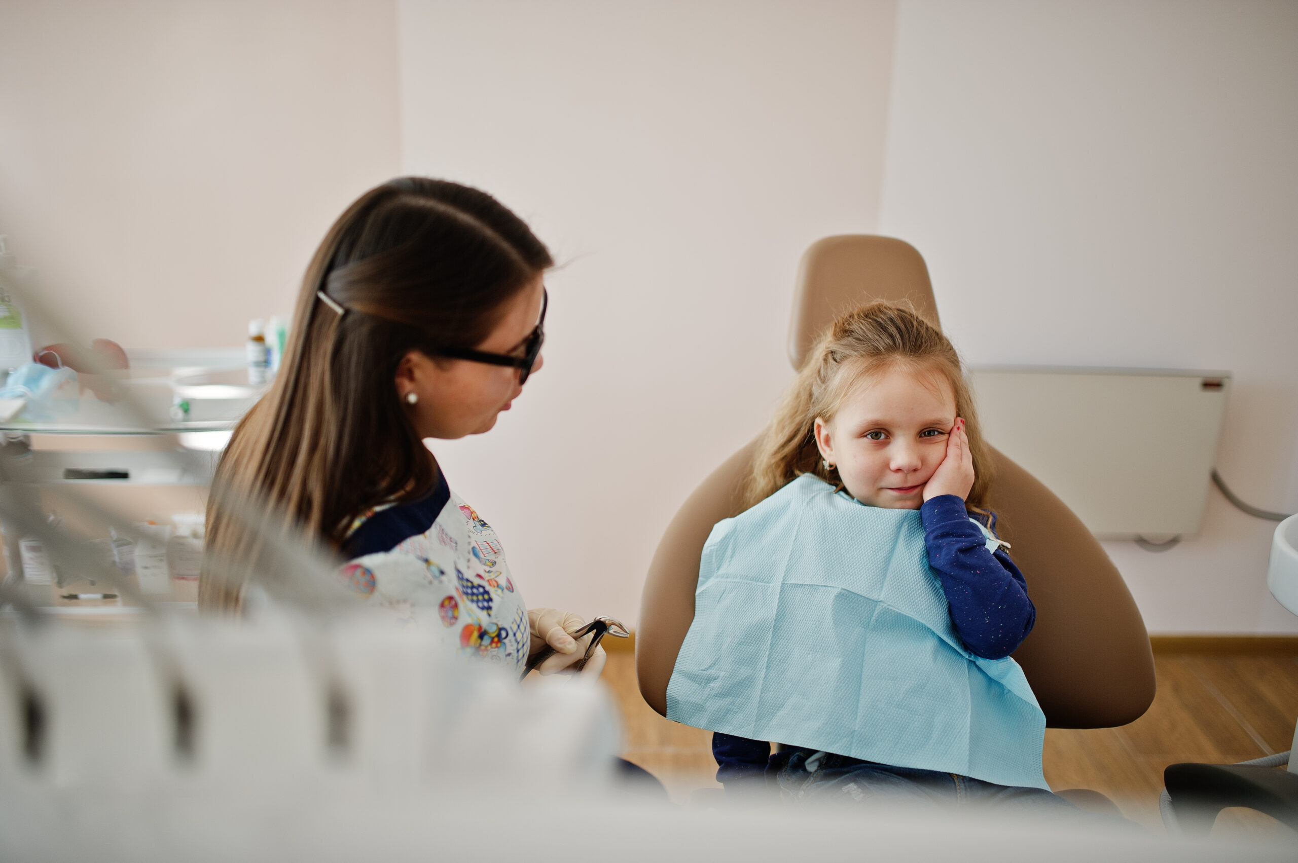 Little baby girl at dentist chair. Children dental.